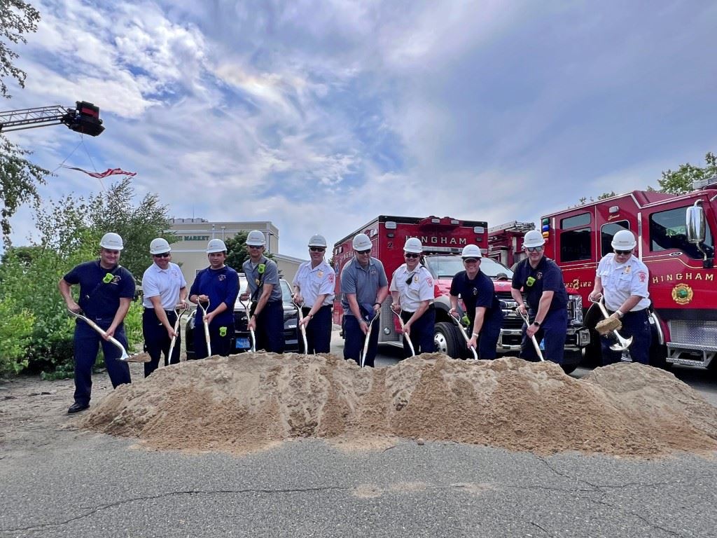 Groundbreaking people with shovels and hardhats
